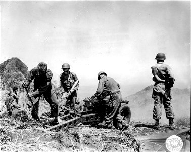 SC 364523 - D Btry., [censored], fire their 75mm gun point blank at caves on hillside.