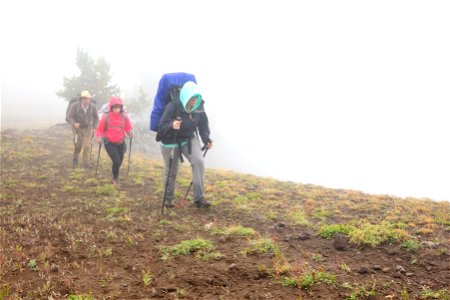 Backpackers in poor visibilty conditions photo