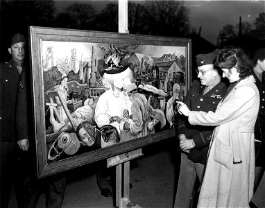 SC 374656 - Miss Barbara Gay of Bristol, England, a British artist, explains the theme of her mural, "War Vs Healing" to Col. William H. Gordon, Detroit, Mich., after having presented it to the hospital at a ceremony recently.