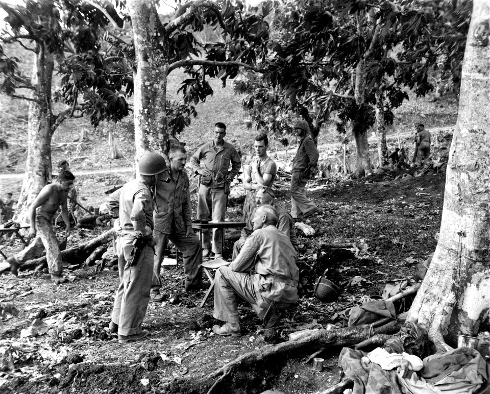Lt. Gen. H. M. Smith, Maj. Gen. Watson, Br. Gen., Erskins, Col. Riseley, Capt. D. V. Nahrgang (R-2) conference at 6th Marine Regiment CP. D plus 3.