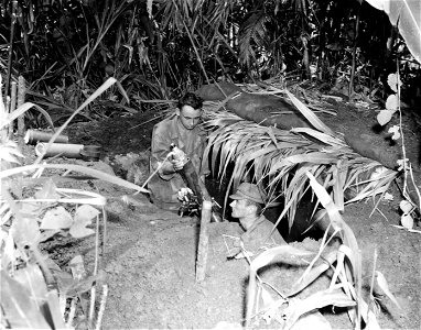 SC 364497 - Pvt. Jack Hunting, Texarkana, Texas, and Pfc. Alfred Livingston, of Company "D", 128th Infantry Regiment, at their 81mm mortar position on the front line.