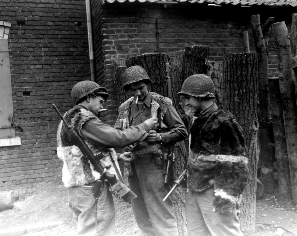SC 337106 - The fur vests that were left behind by retreating Germans are now in possession of three sergeants of Company H, 414th Regt., U.S. First Army.