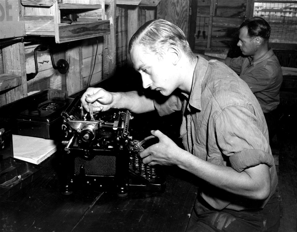 SC 184883 - This German prisoner of war, a former watchmaker, now repairs typewriters at Camp Wallace, Texas, as a part of his assigned work. 1943.