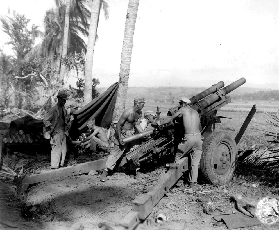 SC 364509 - #1 Gun crew of 105mm howitzer (Batry C, [censored] F.A., 43rd Div.) preparing to fire on enemy positions from White Beach #2, 2 miles north of San Fabian, Luzon, P.I.