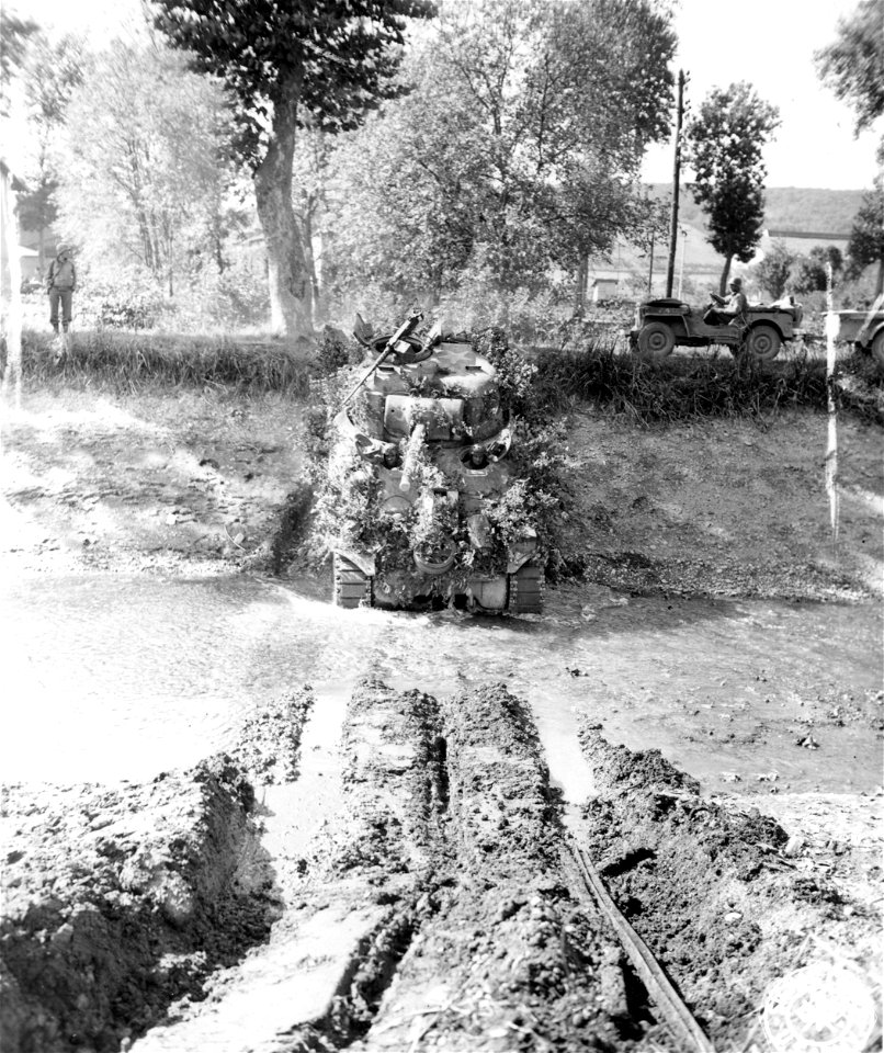 SC 195550 - Members of an American tank unit ford the National Canal, near Bayon, France, as they follow the Germans retreating back towards the German frontier. 12 September, 1944.