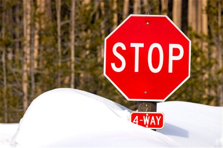 Spring biking road conditions 2023: stop sign under snow