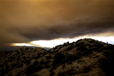 Smoke from the Apple Fire over desert hills photo