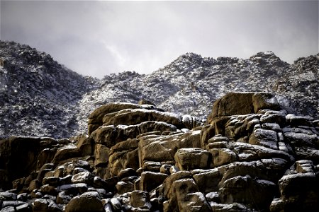 Dusting of snow on monzogranite boulders photo
