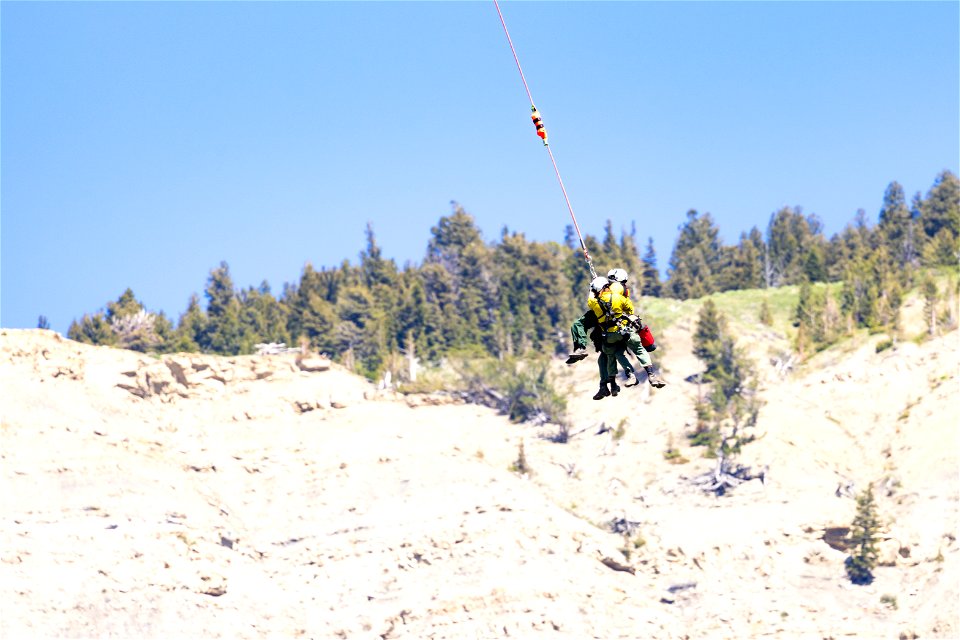 Yellowstone Helitack short-haul training: crew hauling patient to safety (2)