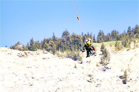 Yellowstone Helitack short-haul training: crew hauling patient to safety (2)