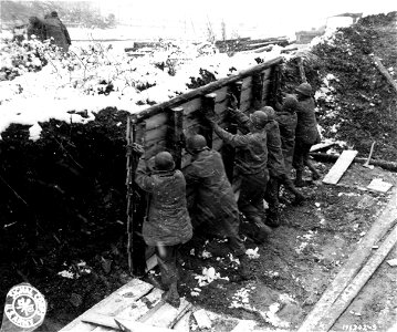 SC 196242 - Up goes a side to start the construction of another winter shelter for troops on the front lines. photo