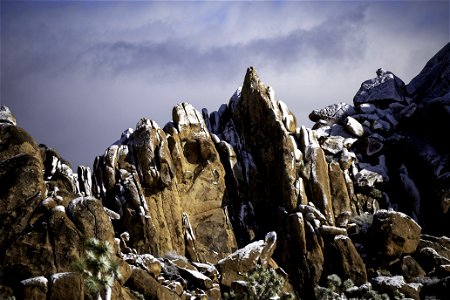 Dusting of snow on monzogranite boulders photo
