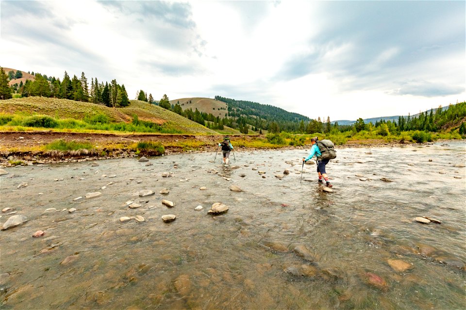 Backpackers crossing Cache Creek