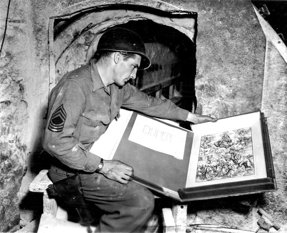 SC 374661 - M/Sgt. Harold Maus of 1109 E. Gibson St., Scranton, Pa., pictured with the Durer engraving, found among other art and treasures in the vault. 15 April, 1945.