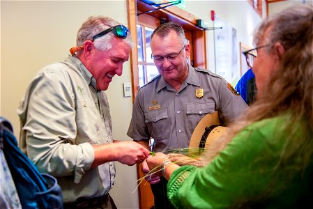 April Martin - Northern Cheyenne braiding sweetgrass with Brian Yablonski (PERC) and Superintendent Cam Sholly