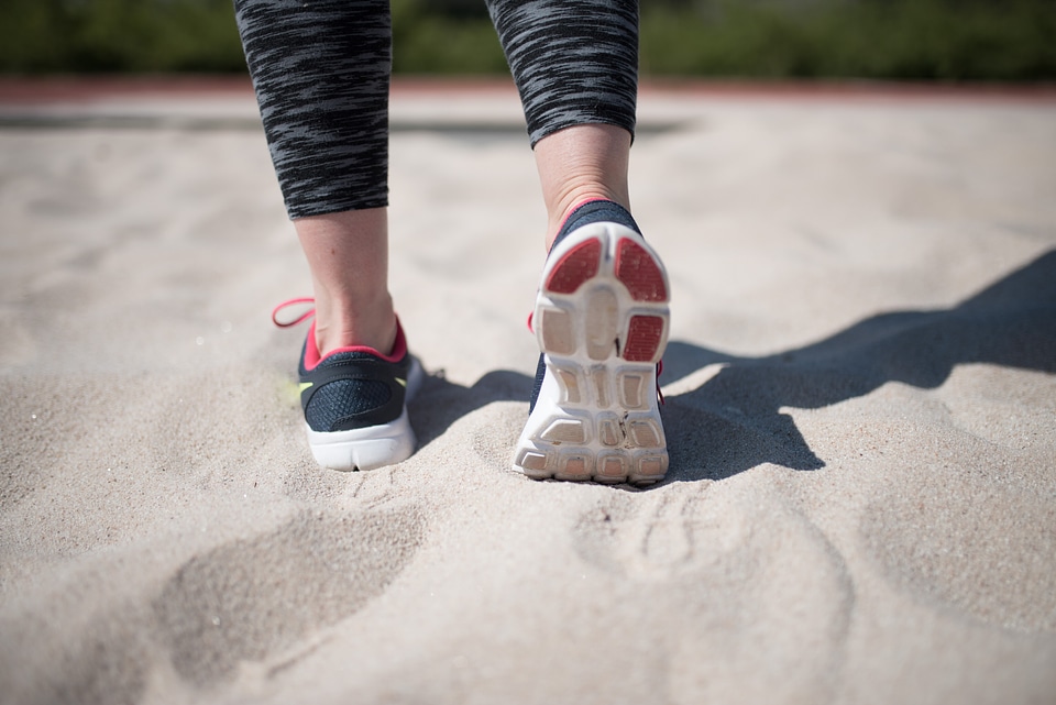 Sporty Woman Walking On Sand photo