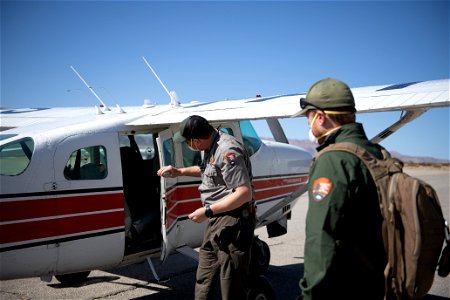 Park rangers next to NPS patrol plane photo