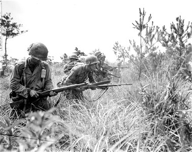 SC 270801 - Soldiers of the 32nd Regt., 7th Inf. Div., advancing to Hill 115 against moderate resistance. 16 June, 1945. photo