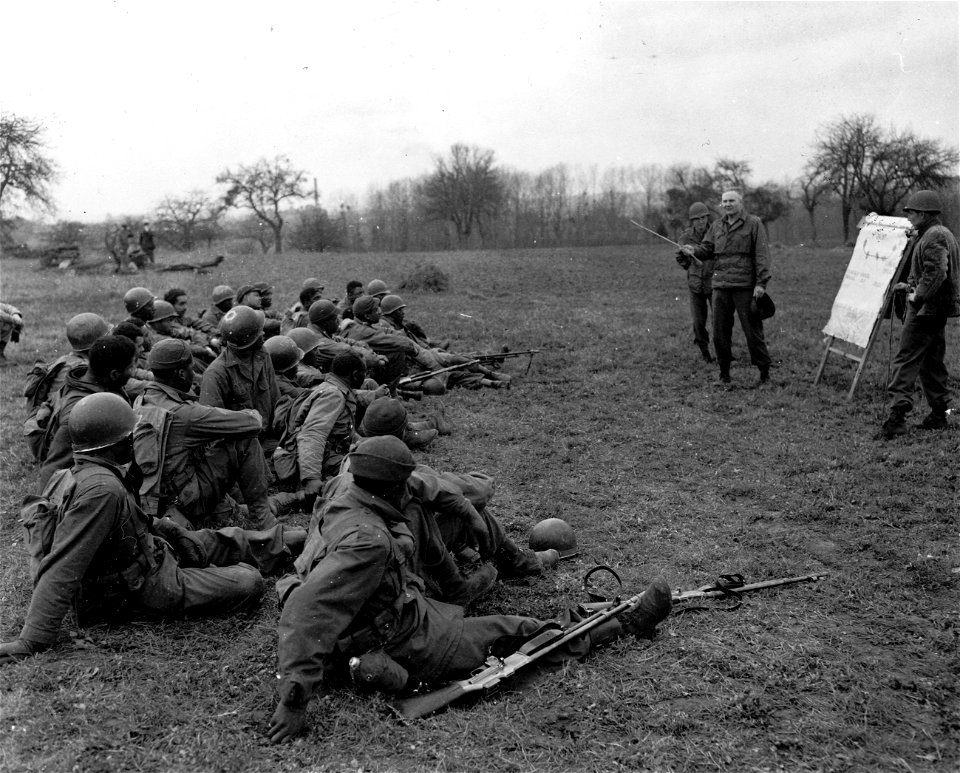 SC 337400 - Lt. Col. Nolan Troxell, 1609 Olive St., Little Rock, Arkansas, veteran combat officer explains the tactics of infantry warfare to a group of Negro soldiers, all volunteers from service units.