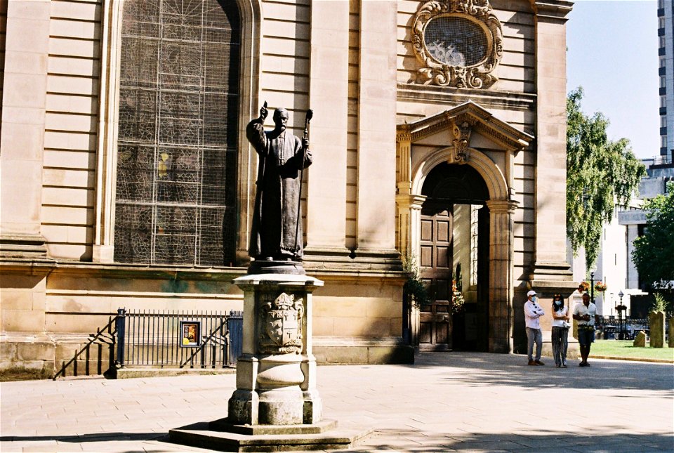 The first bishop of Birmingham stands outside his cathedral.