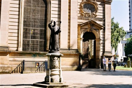 The first bishop of Birmingham stands outside his cathedral. photo