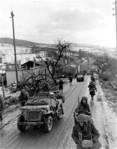 SC 199012-S - Reinforcements for front line duty move through Apach, France. 21 January, 1945. photo