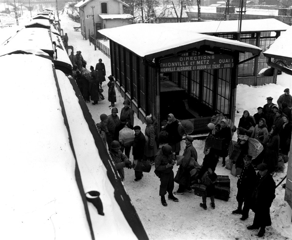 SC 405011 - Soldiers of Civil Affairs Regiment load Russian refugees onto a train at a railroad station in Hayange, France.