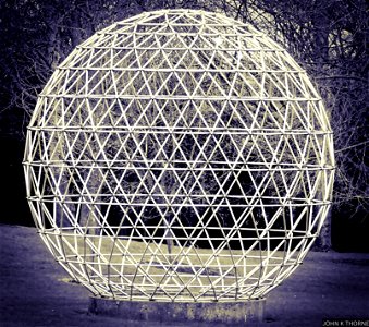 A geodesic dome is a hemispherical thin-shell structure photo