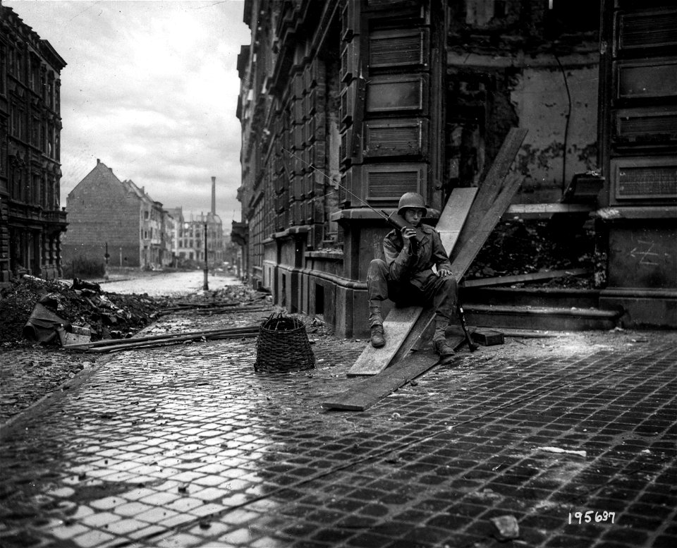 SC 195637 - In Aachen, Germany, Pfc. Ragnel Lundgren, Jamestown, New York, maintains continuous communications with his headquarters with a handie-talkie radio. 15 October, 1944.