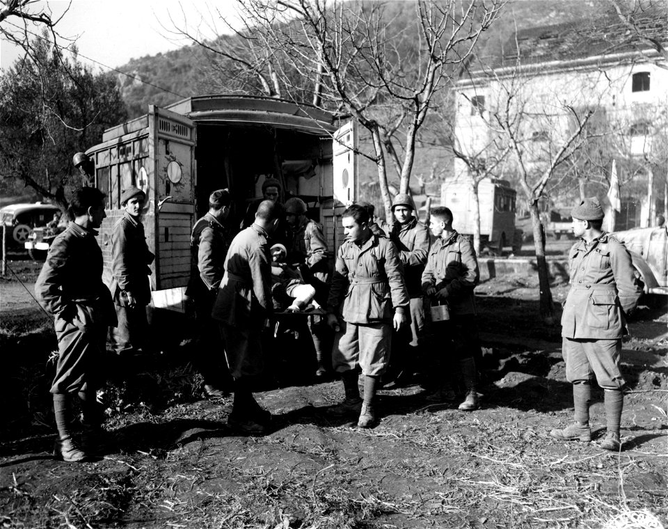 SC 184723 - Wounded Italian is taken from ambulance at 51st Medical Clearing Station (Italian).