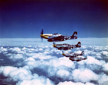 C-1098 - A stacked-down echelon of P-51 Mustang fighters heading homeward after an uneventful bomber escort mission over Europe, photo