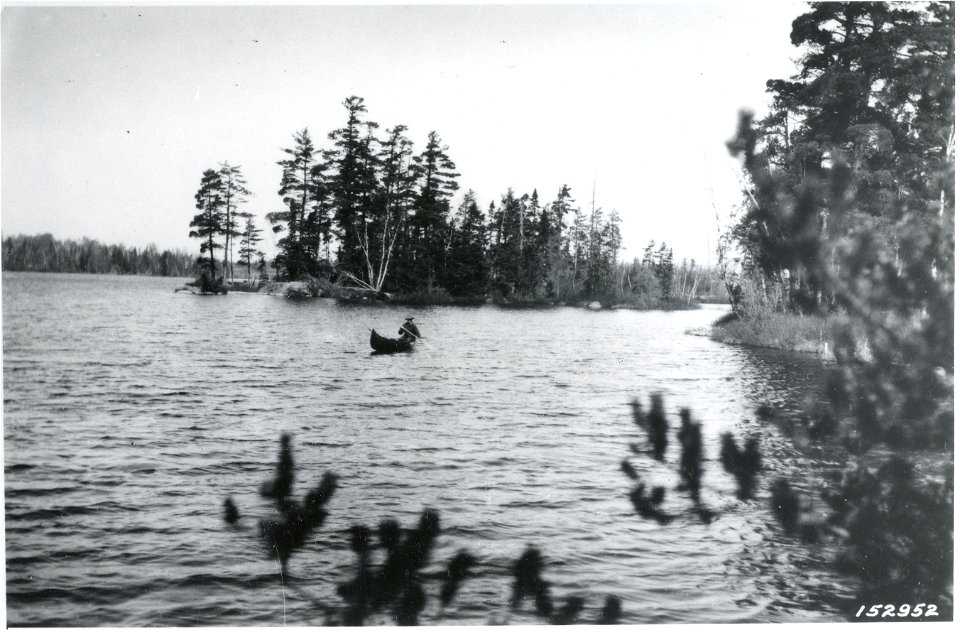 Carhart paddling by two of the five islands on Clear Lake where camps may be made, 1921