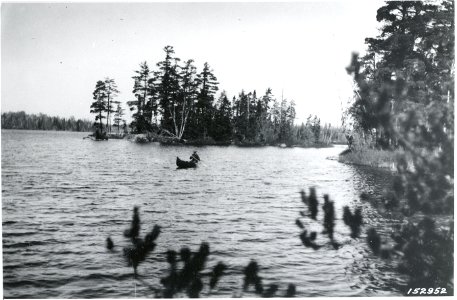 Carhart paddling by two of the five islands on Clear Lake where camps may be made, 1921 photo