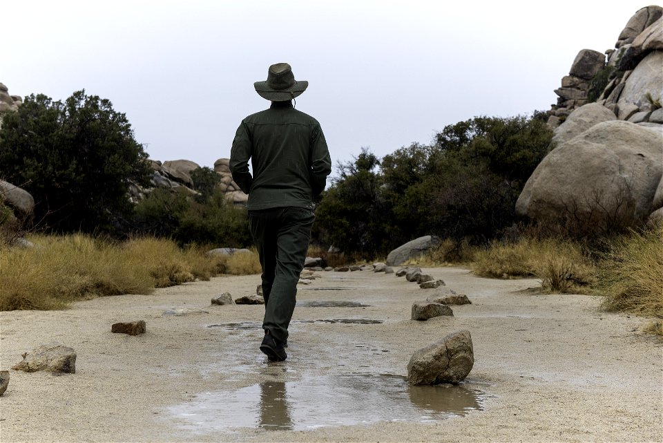 Park ranger in the rain at Barker Dam Trail photo