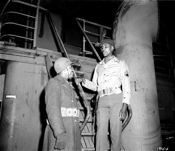 SC 171515 - Pvt. Isaac Bartell, left, Detroit, Mich., gets last-minute instructions from S/Sgt. Thomas A. Blackstone, Leonardtown, Md., as they prepare to go overseas.