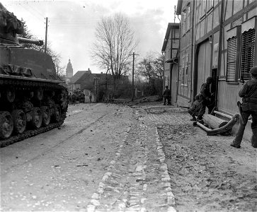 SC 335616 - Tanks and infantry of the 6th Armored Division, 3rd U.S. Army, advance cautiously to take the town of Oberdorla, Germany. 4 April, 1945. photo