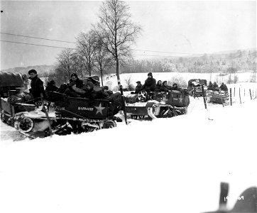 SC 199069 - Bren gun carriers of a British convoy avoid slick roads of Belgium by cutting across country. Leignon area, Belgium. 8 January, 1945. photo