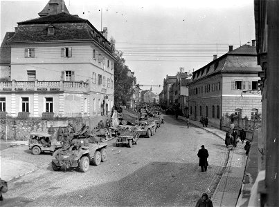 SC 336836 - A 3rd U.S. Army armored convoy lines the streets of Simbach, Germany, waiting to cross the bridge over the Inn River into Braunau, Austria, birthplace of Hitler. 4 May, 1945. photo
