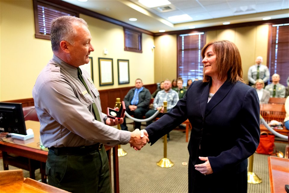 Cam Sholly, Superintendent Yellowstone, presents Stephanie Hambrick, U.S. Magistrate Judge, the superintendent's medallion