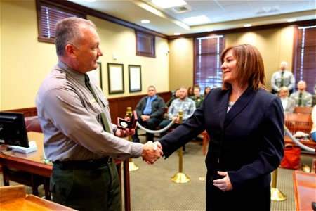 Cam Sholly, Superintendent Yellowstone, presents Stephanie Hambrick, U.S. Magistrate Judge, the superintendent's medallion