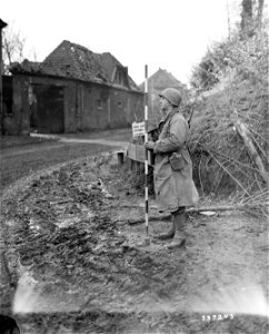SC 337243 - Pvt. Joe Frank of Long Island, N.Y., a rear-rodman, surveys a road. 26 November, 1944.