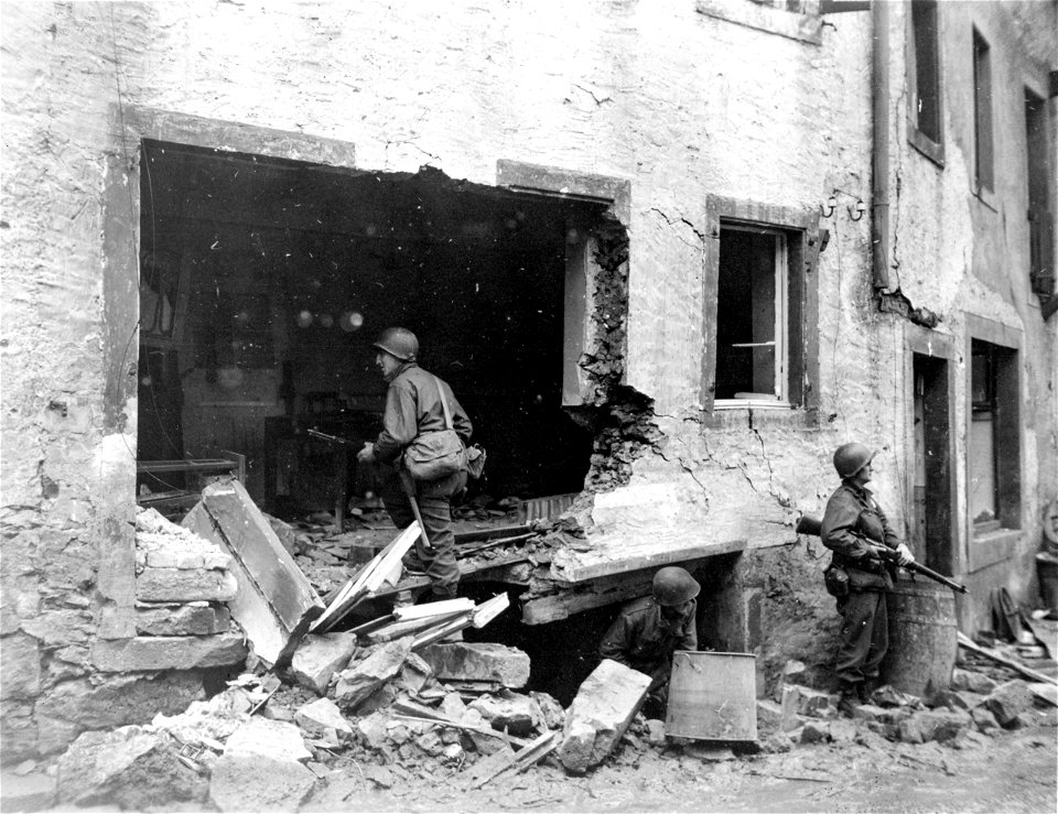 SC 336801 - Men of the 328th Infantry Regt., 26th Infantry Division, inspect a house for a possible sleeping quarters in the recently captured town of Serrig, Germany.