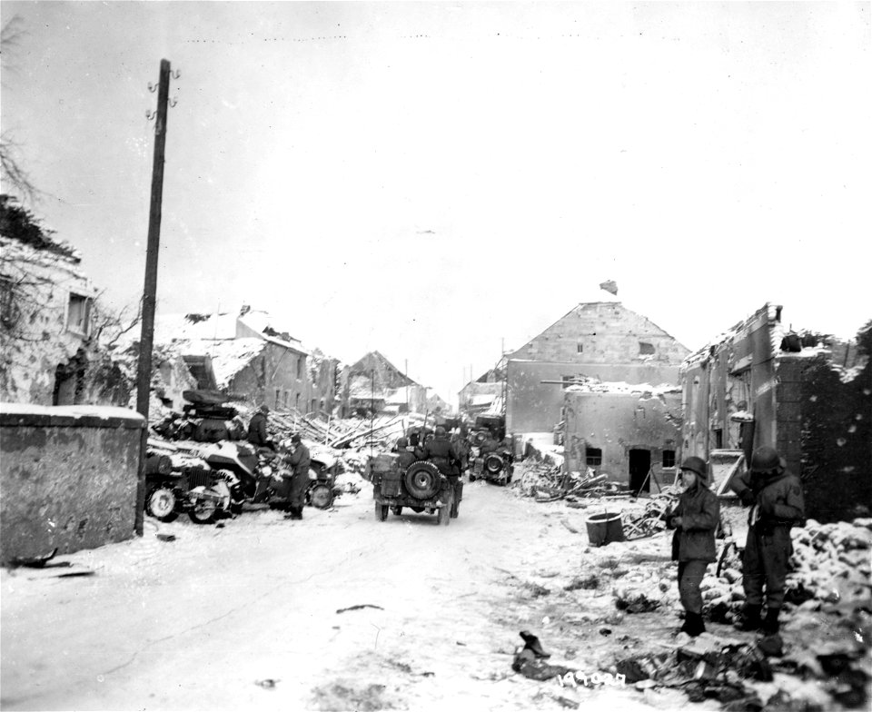 SC 199027 - Vehicles and men of a cavalry group take time out amidst the snow-covered ruins of Ischpelt, Luxembourg.