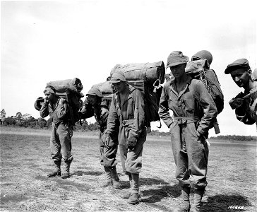SC 166668 - A hospital unit treks along the front after landing from transport plane in New Guinea. 15 December, 1942.
