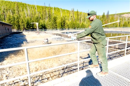 Brett Thielke, wastewater facility operator, taking sample photo