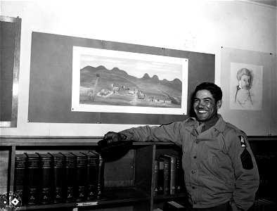 SC 374644 - M/Sgt. Mario Hidalgo, member of Camp Aldair enlisted mens art workshop in Service Club #1, stands beside his memory picture of the famous Texas town of Langtry, named for Lillian Langtry by the famous frontiersman Judge Roy Bean.