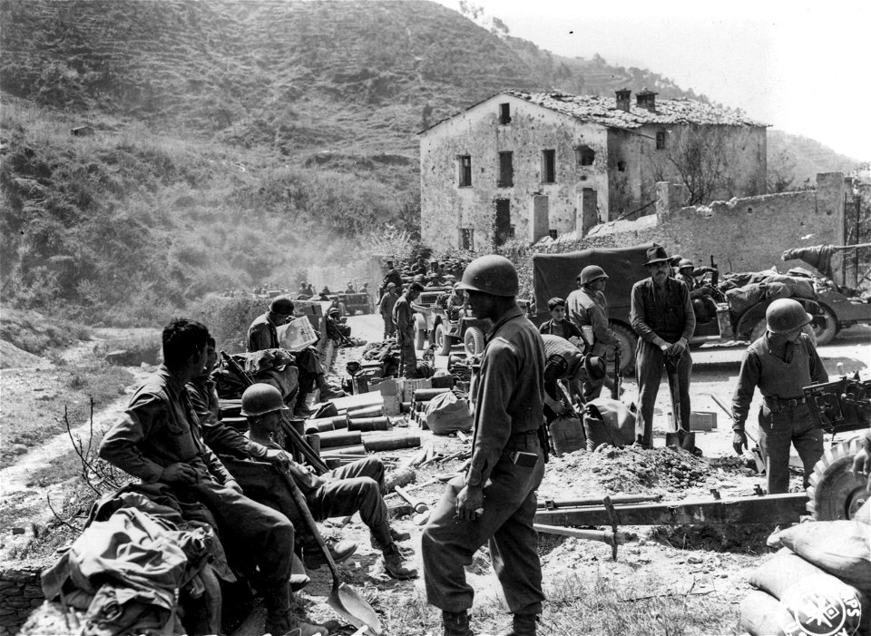 SC 337153 - Traffic gets snarled up on narrow, one-way road in Prato. In foreground are men of Cannon Co., 442nd Inf. Regt. 9 April, 1945. photo