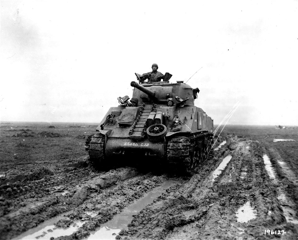 SC 196127 - Tank moves through thick mud in France to demonstrate one of newly-installed "Duck Bills" on outside of tracks for better traction. 5 November, 1944.