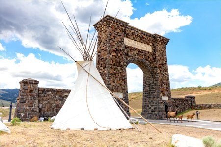 North Entrance teepee installation event: teepee, Roosevelt Arch, and elk cow and calves