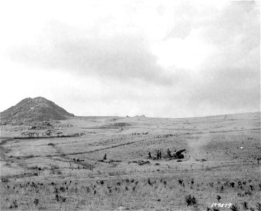 SC 179877 - Members of a field artillery unit fire a 105mm howitzer. Sicily. 14 August, 1943. photo